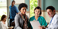 medical professionals discussing records with patient